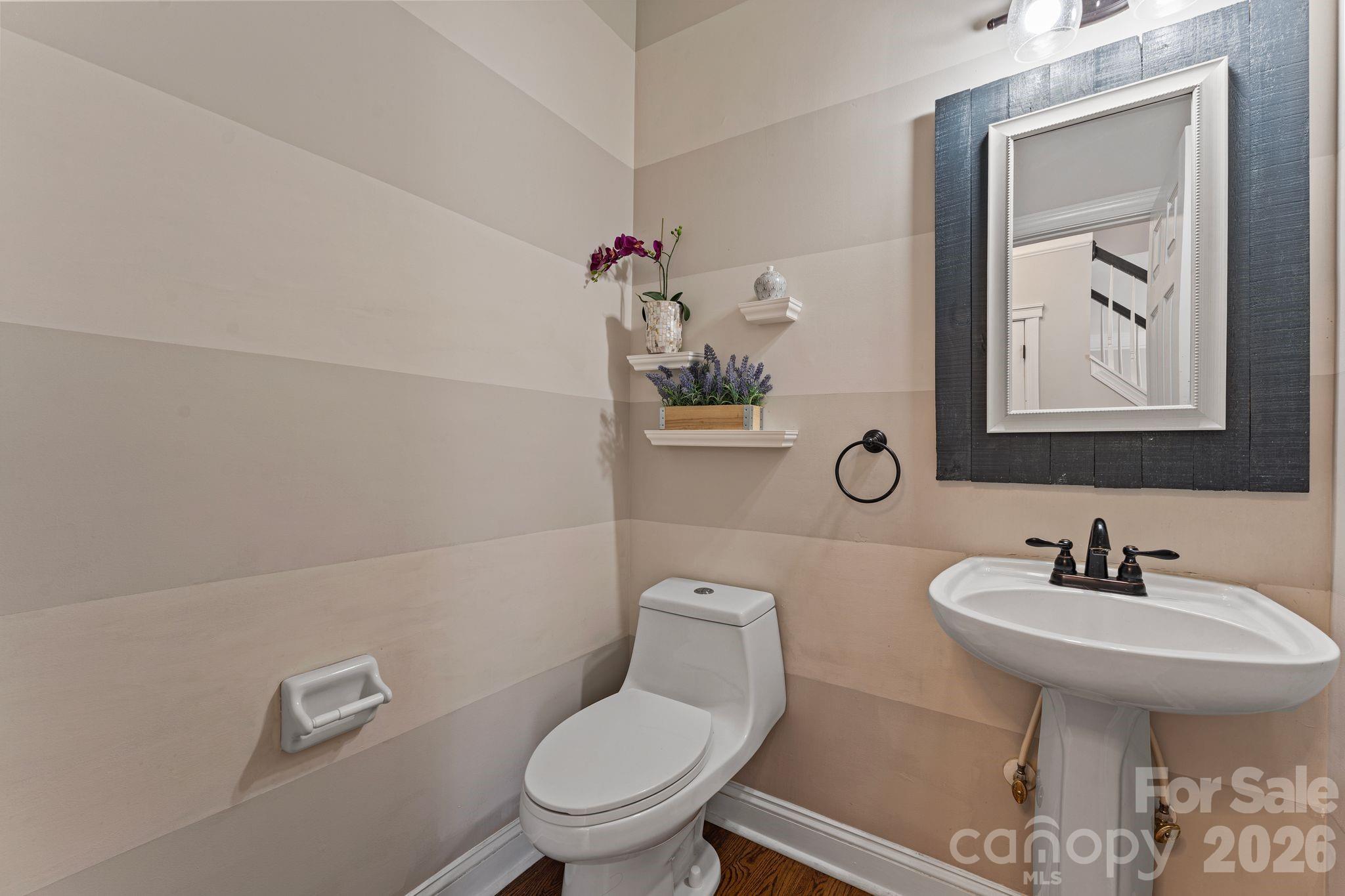9618 Cockerham Lane Huntersville, NC 28078 - Photo 14 of 37 a bathroom with a toilet a sink and mirror