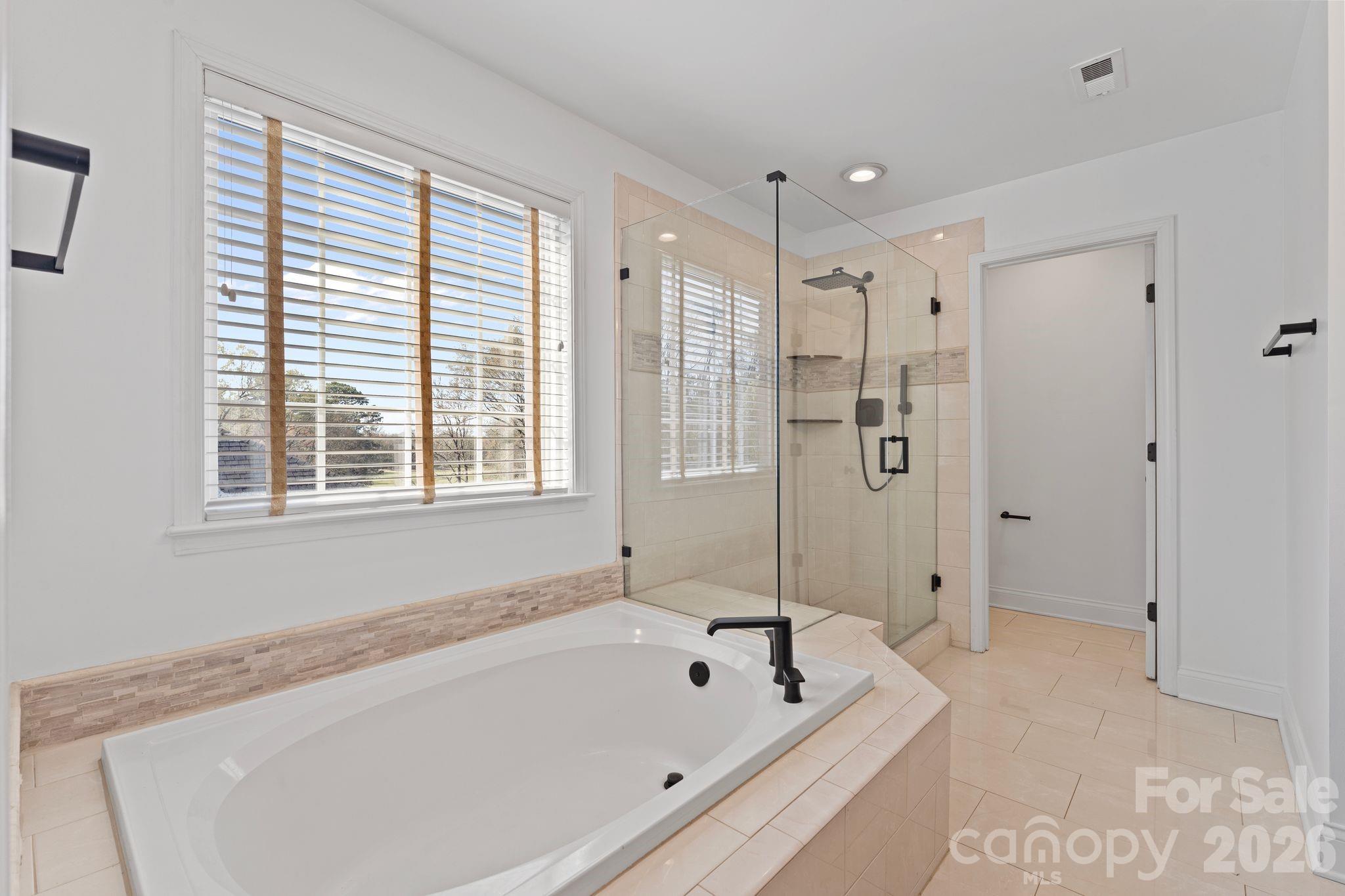 9618 Cockerham Lane Huntersville, NC 28078 - Photo 18 of 37 a bathroom with a bathtub and a shower