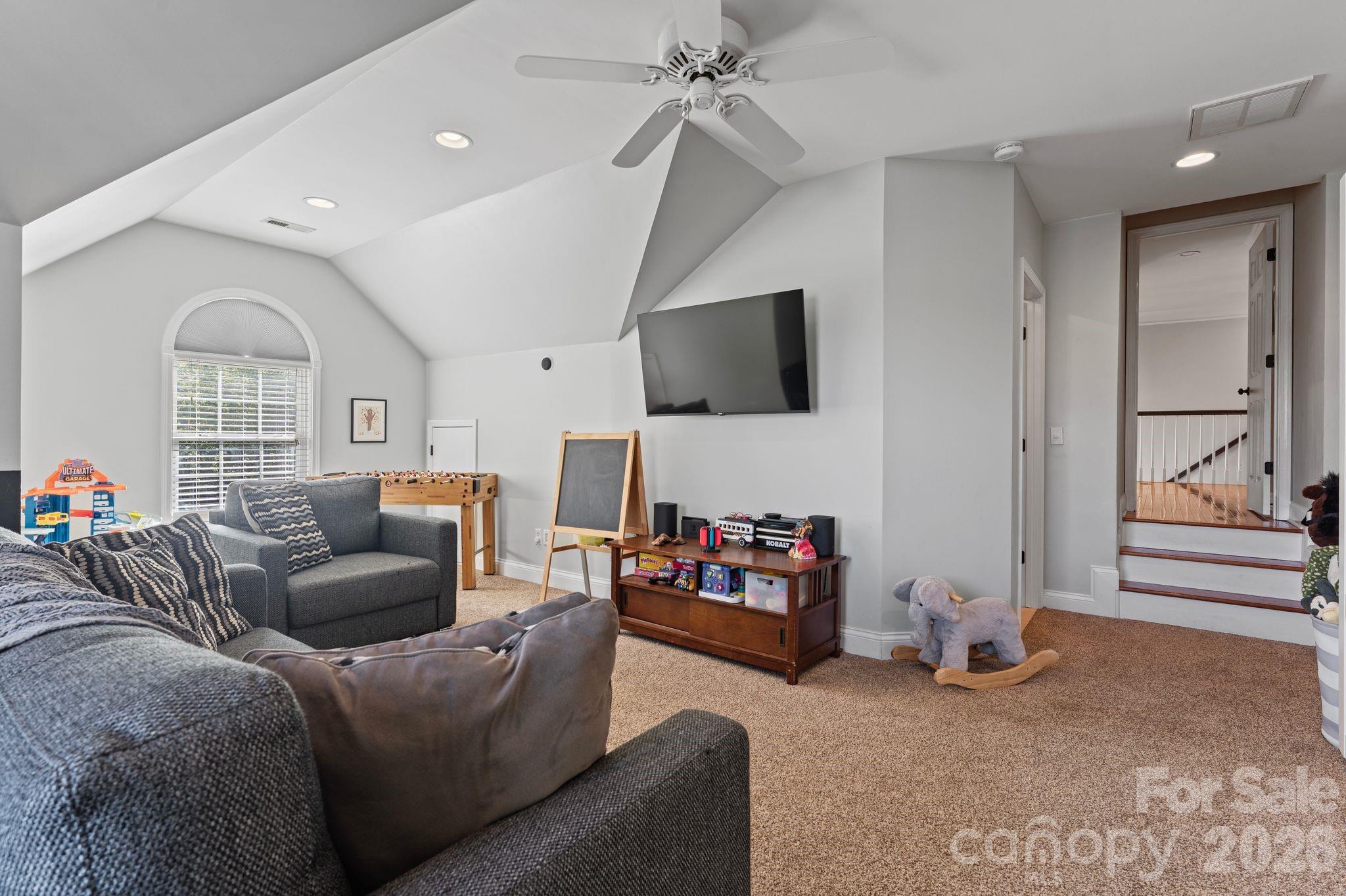 9618 Cockerham Lane Huntersville, NC 28078 - Photo 26 of 37 a living room with furniture and a flat screen tv