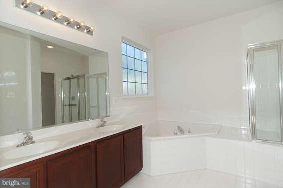 11012 Old York Road Bowie, MD 20721 - Photo 17 of 30 a bathroom with a bathtub sink vanity and mirror