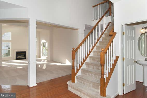 11012 Old York Road Bowie, MD 20721 - Photo 4 of 30 a view of staircase with wooden floor and a chandelier