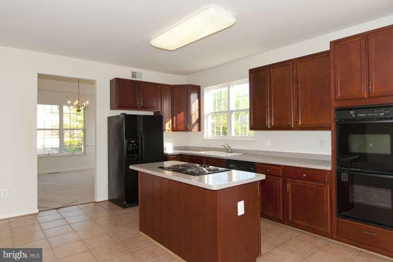 11012 Old York Road Bowie, MD 20721 - Photo 9 of 30 a kitchen with stainless steel appliances granite countertop a stove a refrigerator and a sink