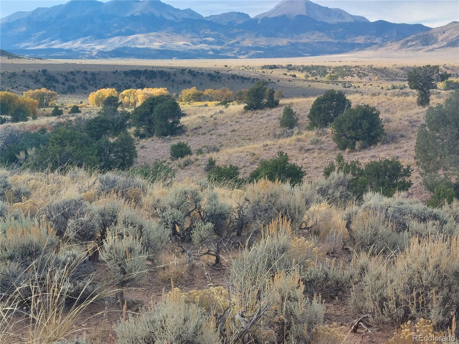 Lot 4132 Barker Road Fort Garland, CO 81133 - Photo 8 of 8 a view of a lake with mountains in the background