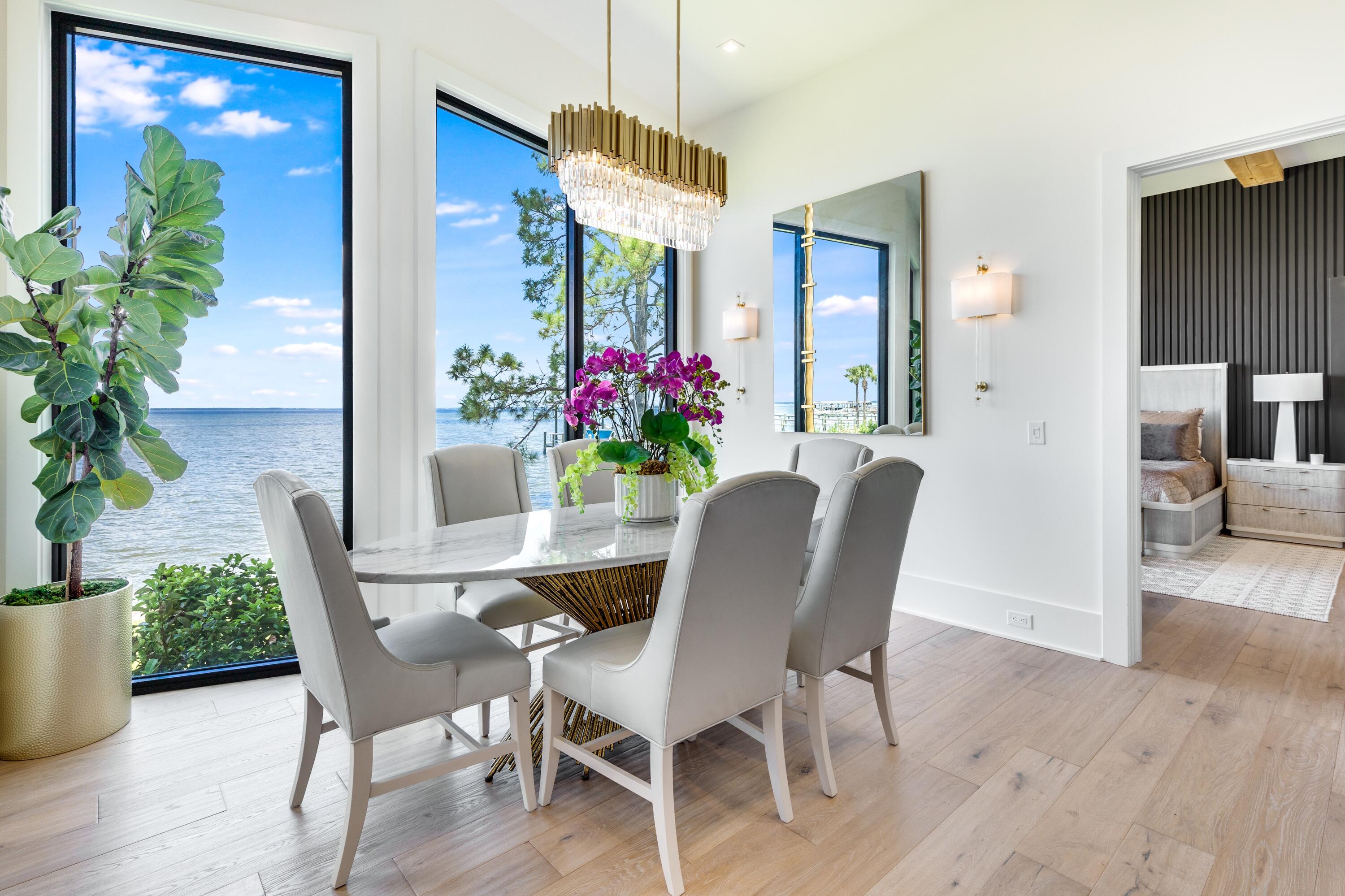 1769 Driftwood Point Road Santa Rosa Beach, FL 32459 - Photo 17 of 70 a dining room with furniture potted plants and wooden floor
