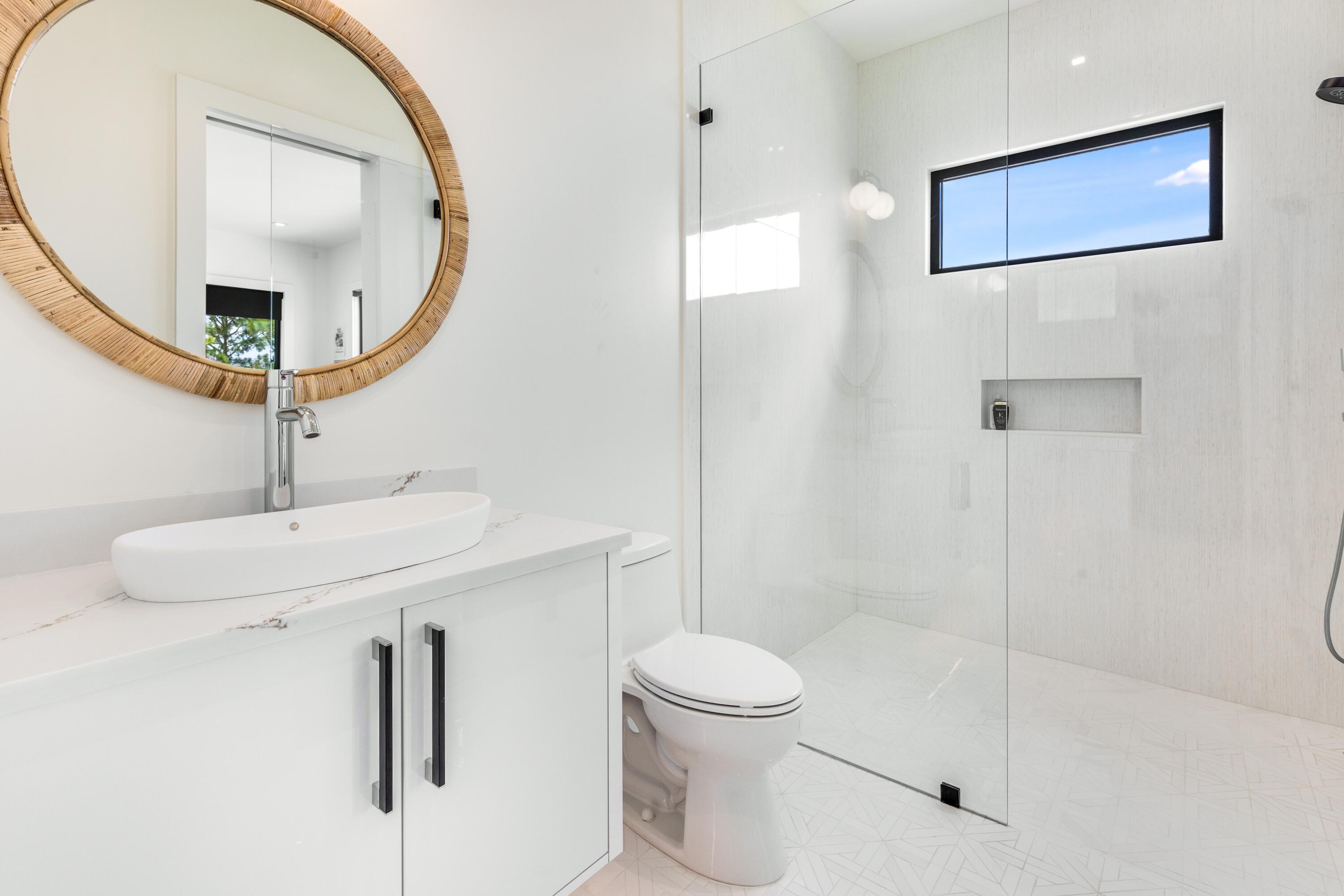 1769 Driftwood Point Road Santa Rosa Beach, FL 32459 - Photo 37 of 70 a bathroom with a toilet a sink and mirror