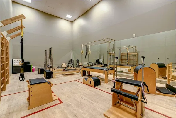 a living room with patio furniture and a wooden floor