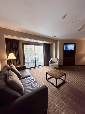 a bedroom with furniture and a large window