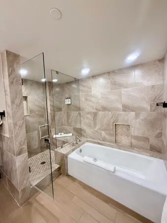 a bathroom with a bathtub and a shower
