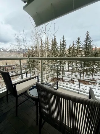 a view of a balcony with wooden chairs and floor