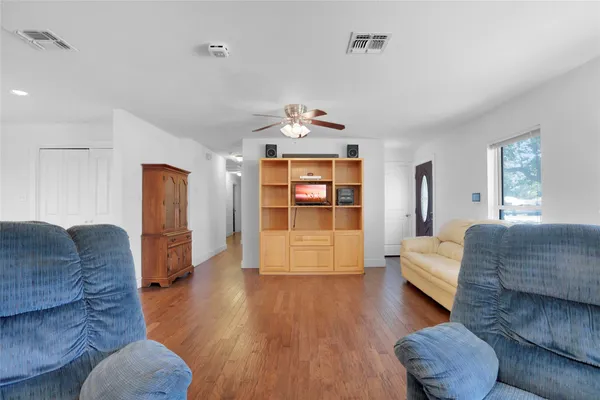 a living room with furniture and wooden floor