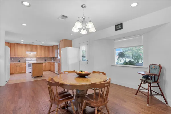 a view of a dining room with furniture wooden floor and a chandelier
