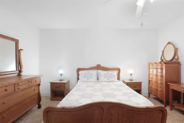 a bedroom with a bed and dresser