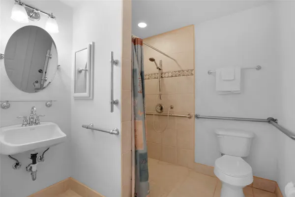 a bathroom with a toilet sink and a mirror