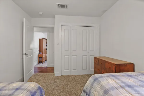 a bedroom with a bed and a view of bathroom