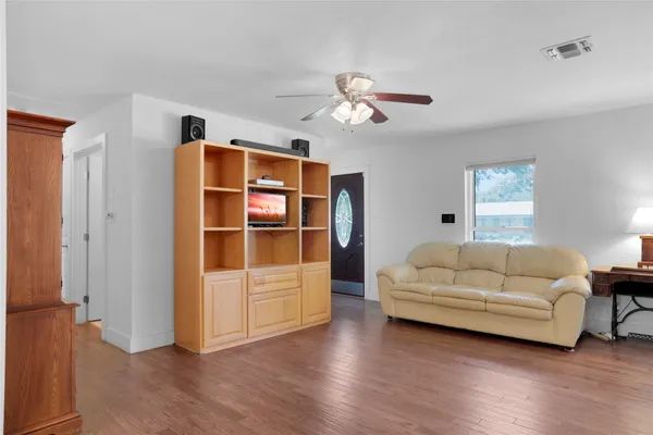 a living room with furniture and wooden floor