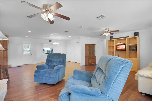 a living room with furniture and a wooden floor