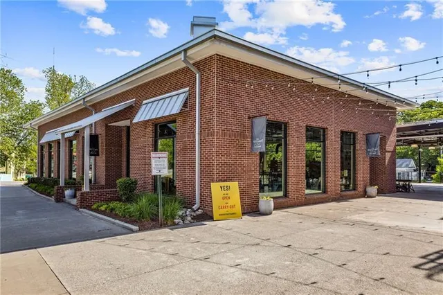a front view of a building with garden