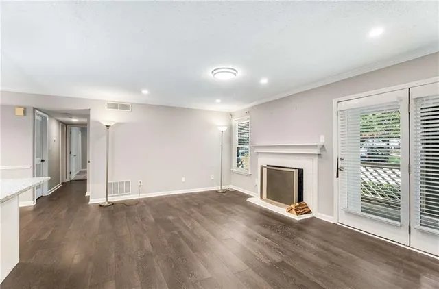a view of empty room with wooden floor