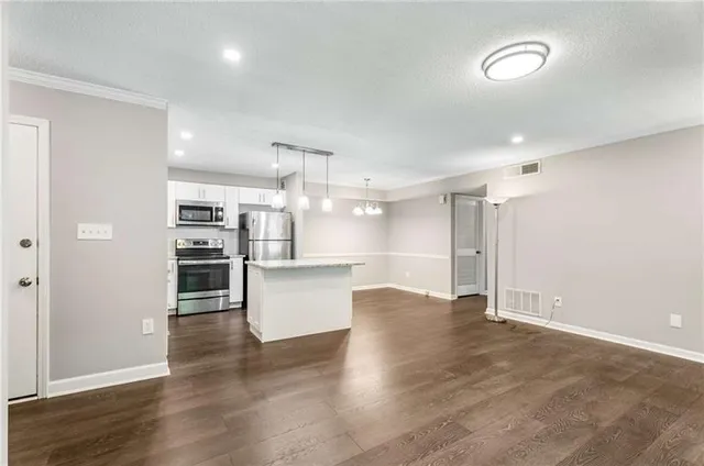 a kitchen with a sink a stove a refrigerator and a sink