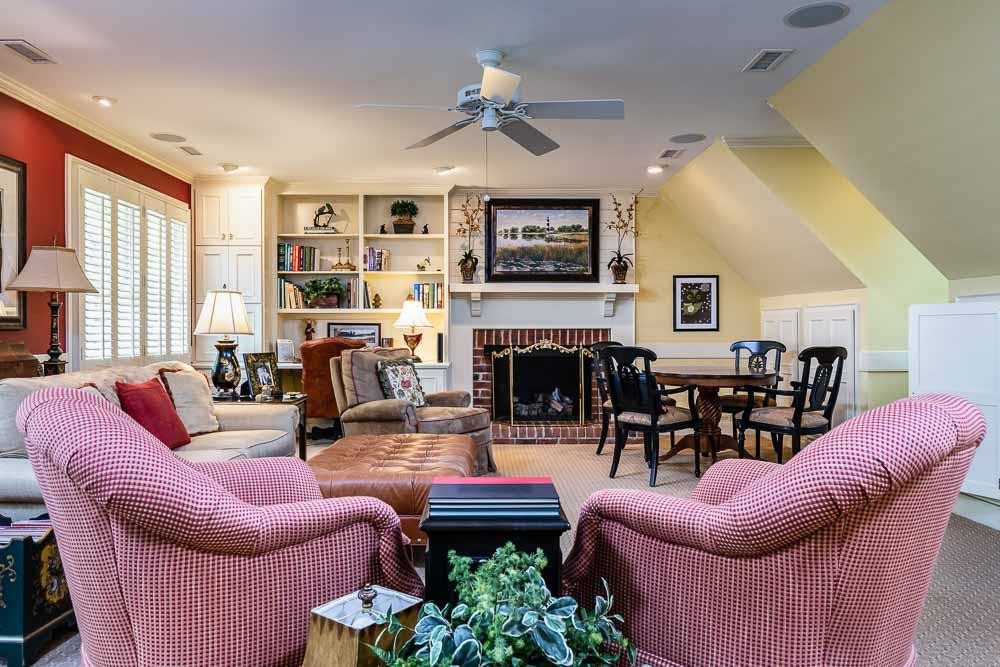 2304 Wheeler Road Raleigh, NC 27612 - Photo 23 of 30 a living room with furniture a fireplace and a flat screen tv