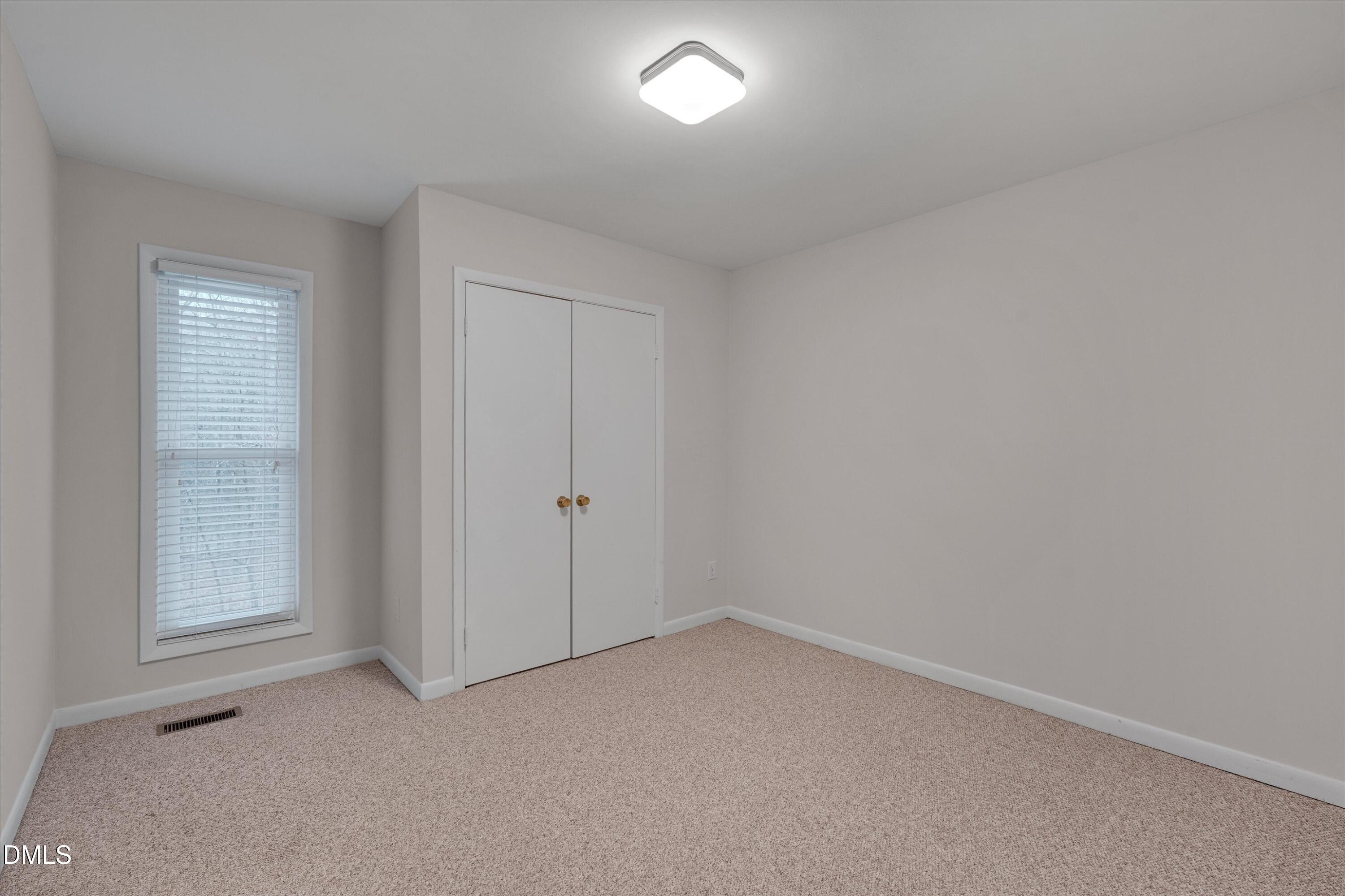 1304 Seaton Road, Unit 2 Durham, NC 27713 - Photo 14 of 19 an empty room with windows and closet
