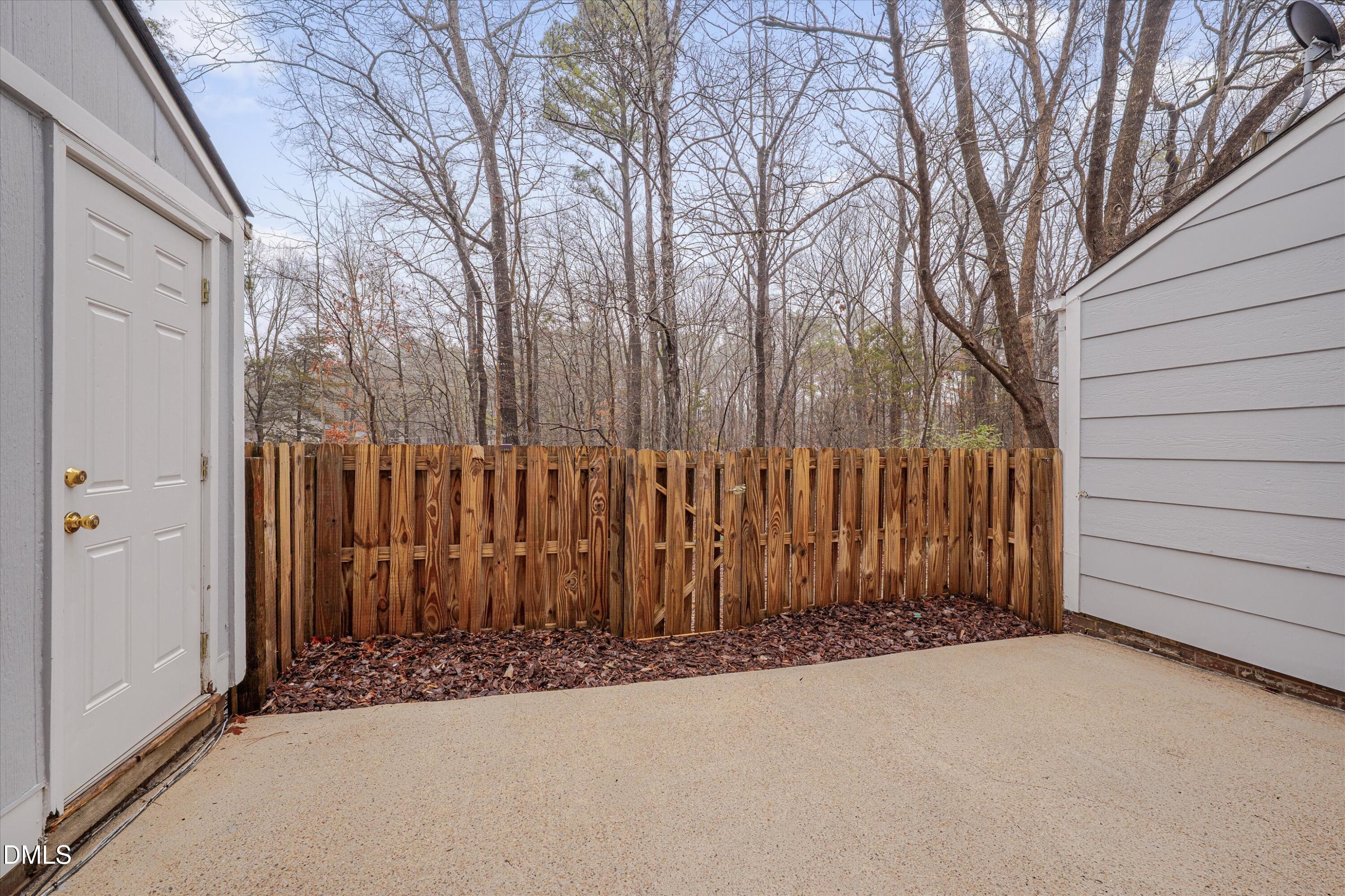 1304 Seaton Road, Unit 2 Durham, NC 27713 - Photo 17 of 19 a view of a house with a wooden fence next to a road