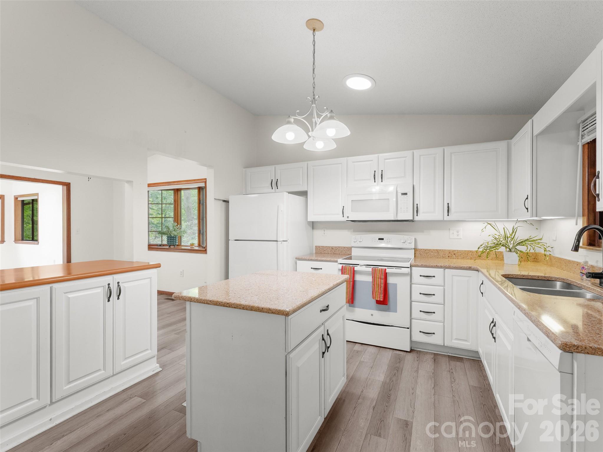 32 Honey Suckle Ridge Road Pisgah Forest, NC 28768 - Photo 6 of 35 a kitchen that has a lot of white cabinets and wooden floor