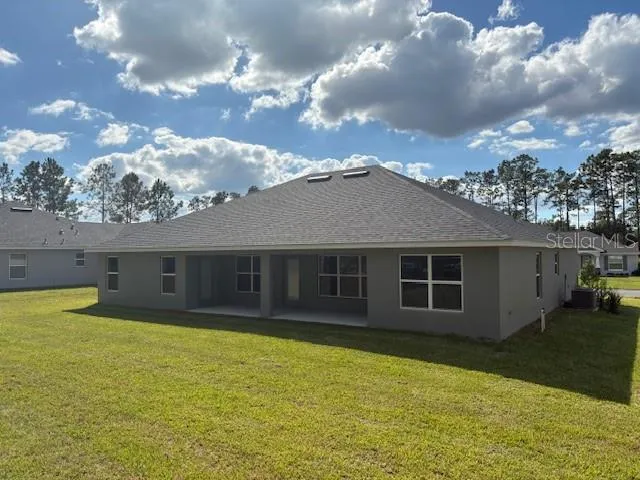 a view of a house with yard and sitting area