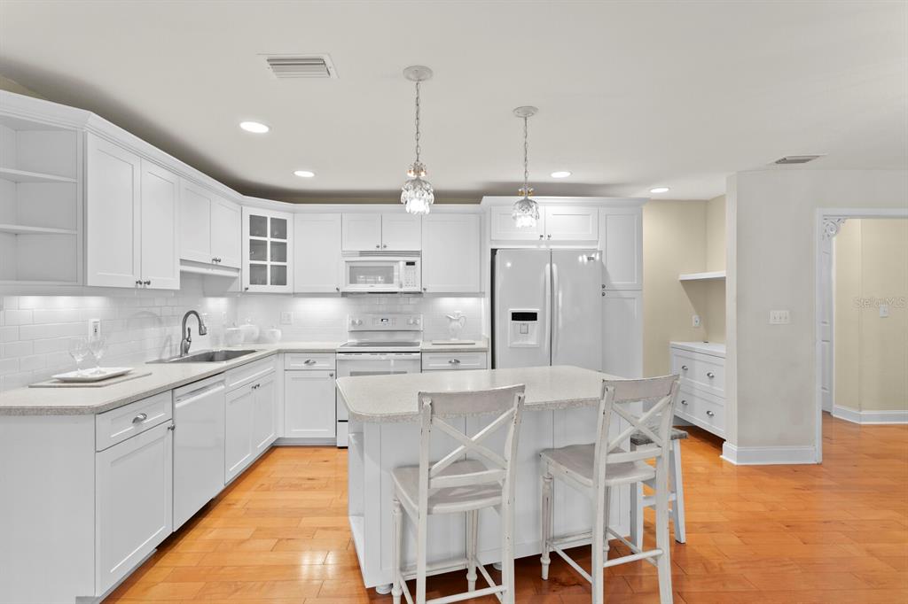 309 Park Ridge Avenue Temple Terrace, FL 33617 - Photo 20 of 60 a kitchen with stainless steel appliances kitchen island granite countertop a sink and cabinets
