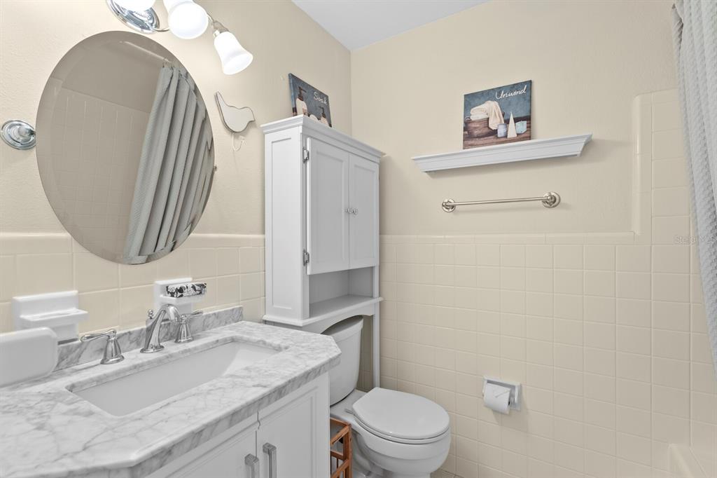 309 Park Ridge Avenue Temple Terrace, FL 33617 - Photo 41 of 60 a bathroom with a granite countertop sink mirror vanity and toilet