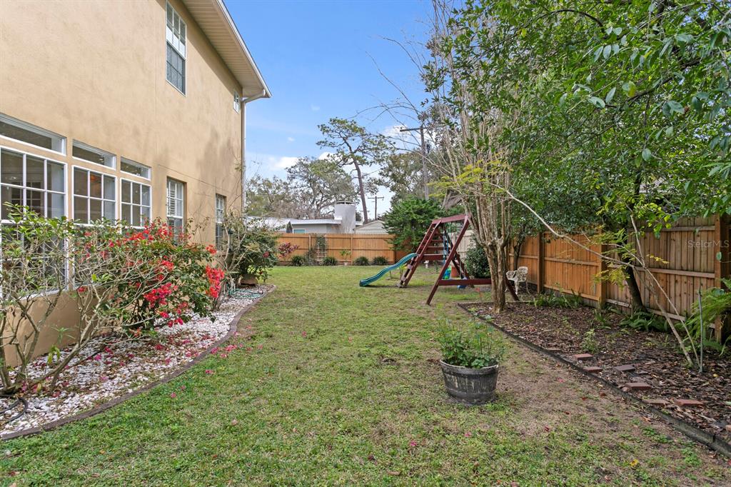 309 Park Ridge Avenue Temple Terrace, FL 33617 - Photo 53 of 60 a view of a backyard with plants and a garden