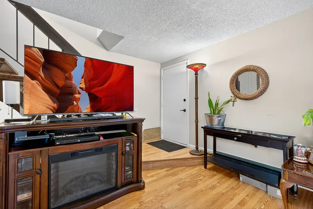 a living room with furniture and a wooden floor