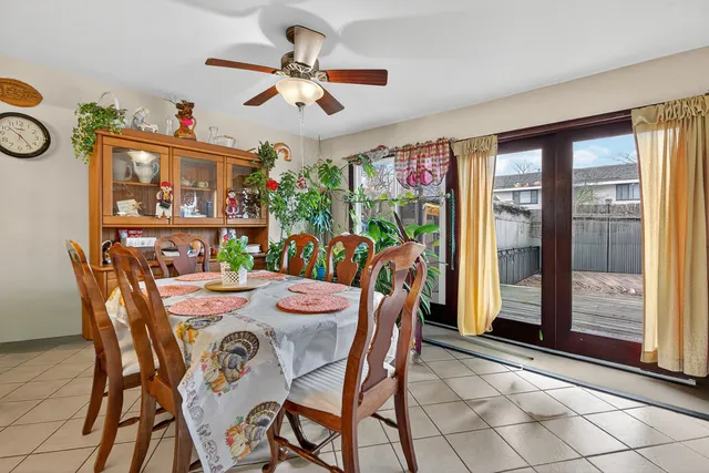 a kitchen with stainless steel appliances granite countertop a sink a stove a refrigerator cabinets and dining table