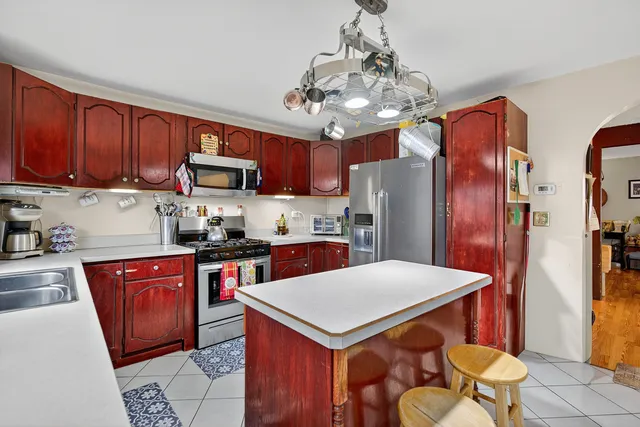 a kitchen with a sink a counter space appliances and cabinets
