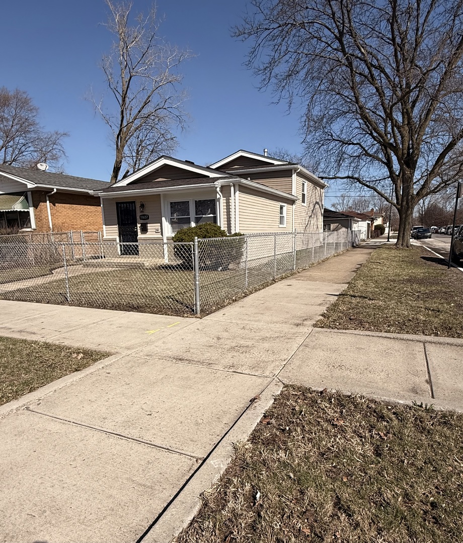 11657 South Racine Avenue Chicago, IL 60643 - Photo 3 of 40 a front view of a house with a yard