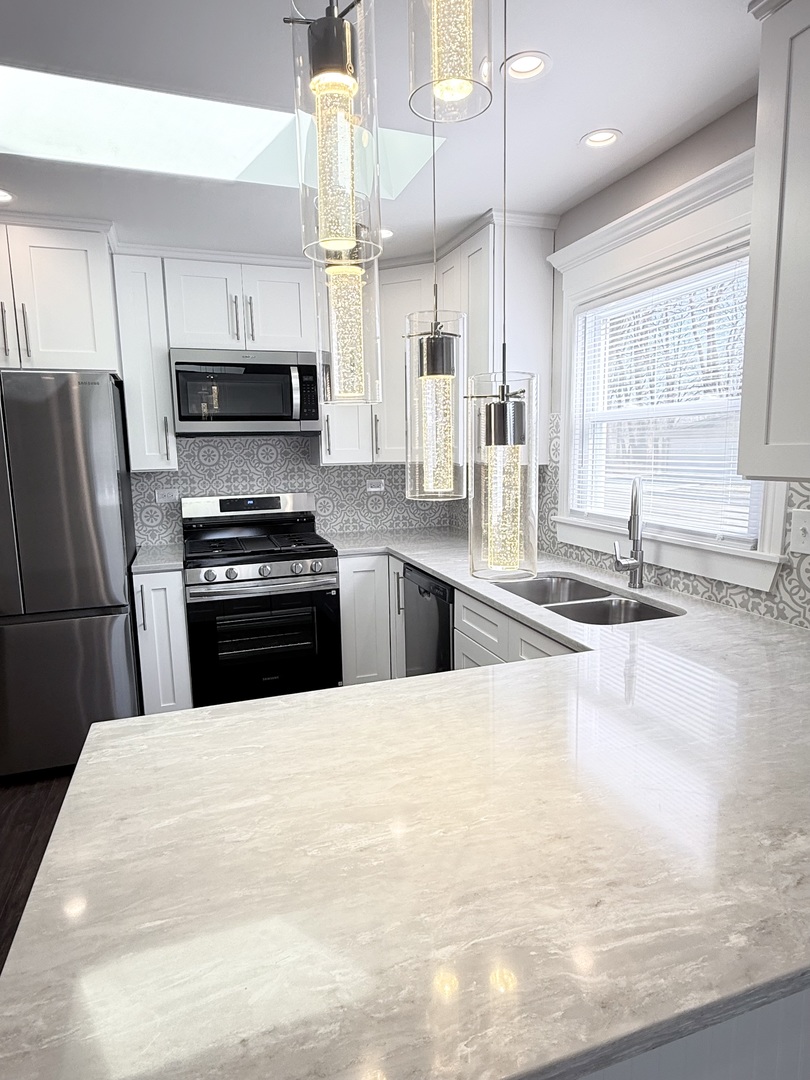 11657 South Racine Avenue Chicago, IL 60643 - Photo 6 of 40 a kitchen with stainless steel appliances a kitchen island sink refrigerator and microwave