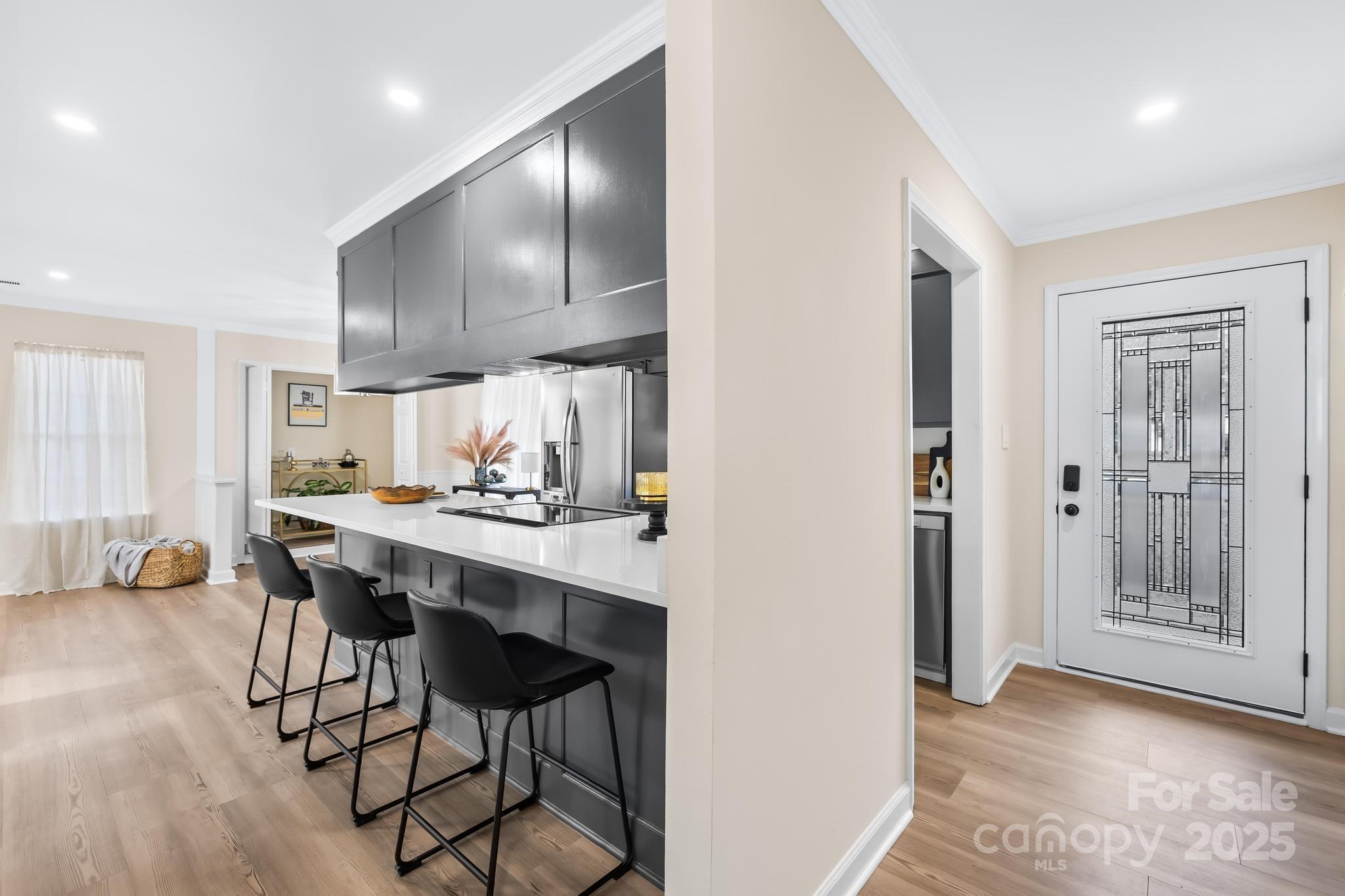 6306 Fox Hunt Road Indian Trail, NC 28079 - Photo 3 of 20 a kitchen with a sink cabinets and chairs