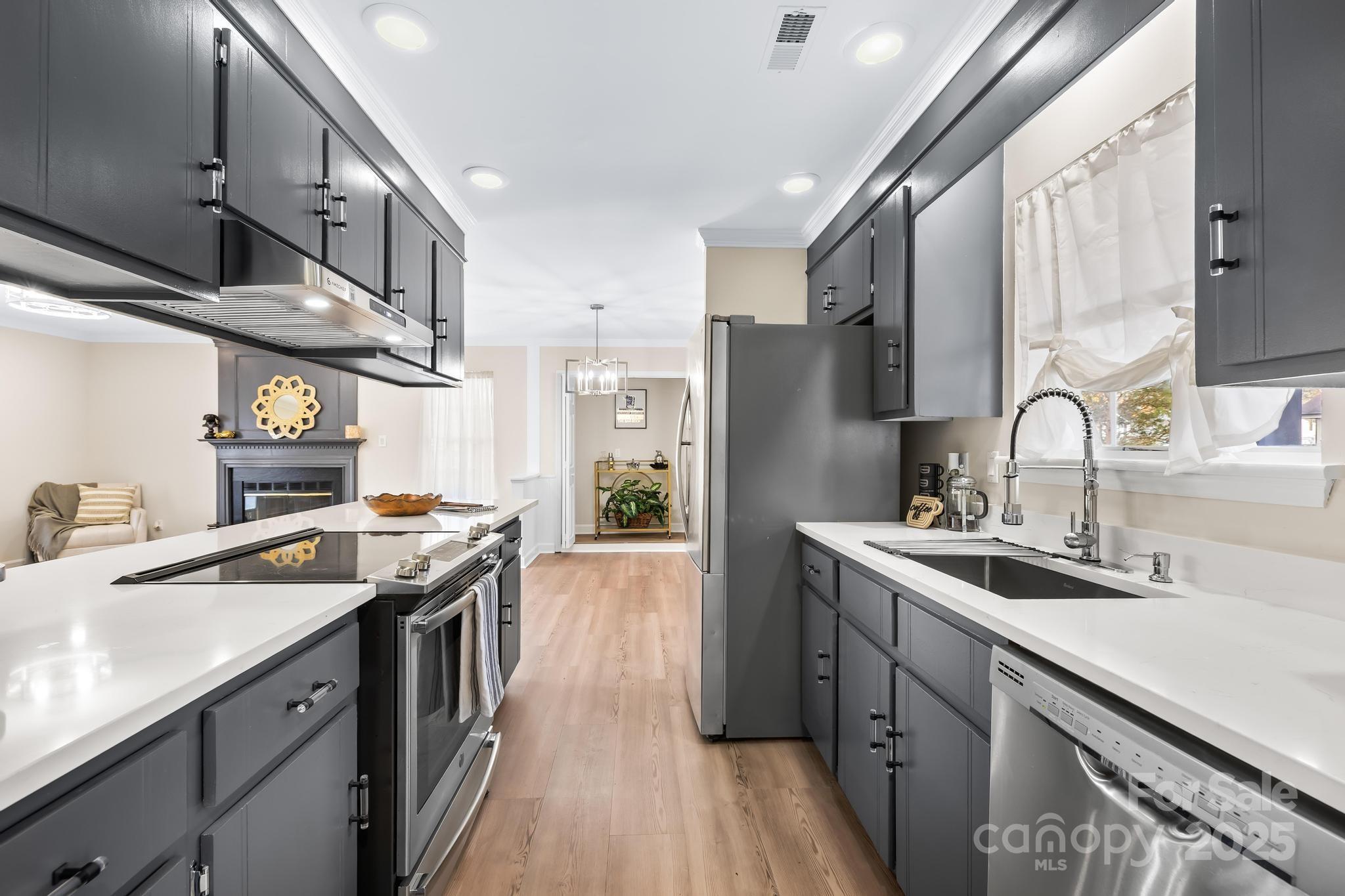 6306 Fox Hunt Road Indian Trail, NC 28079 - Photo 4 of 20 a kitchen with stainless steel appliances granite countertop a sink stove and refrigerator
