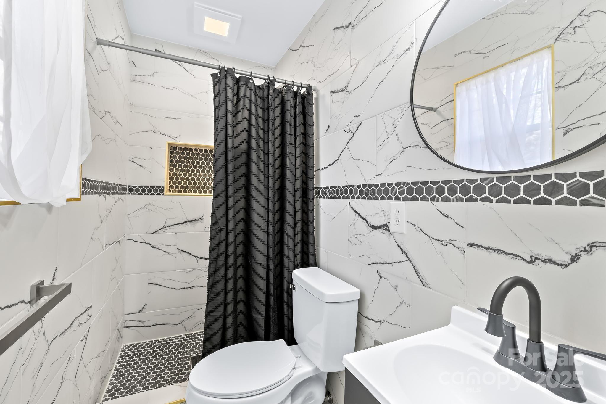 6306 Fox Hunt Road Indian Trail, NC 28079 - Photo 7 of 20 a bathroom with a sink toilet and shower