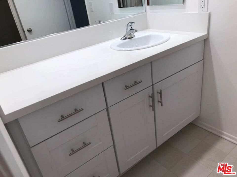 11730 Sunset Boulevard Los Angeles, CA 90049 - Photo 18 of 20 a bathroom with a sink and a mirror