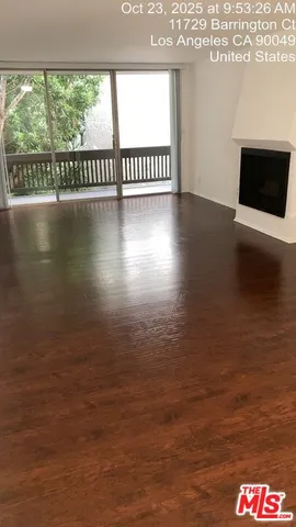 a view of a floor to an empty room and window