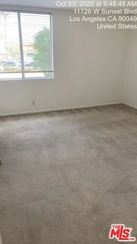 a view of an empty room and a window