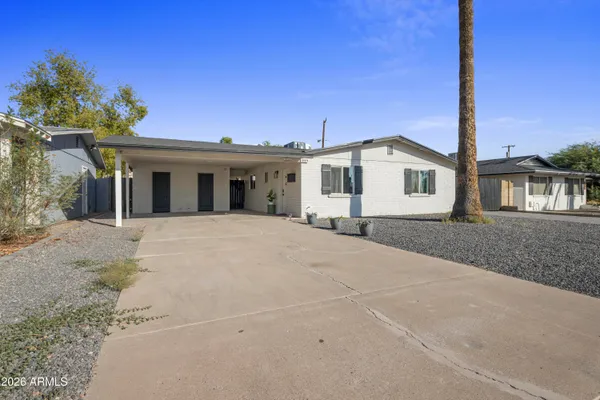 a view of house with a yard