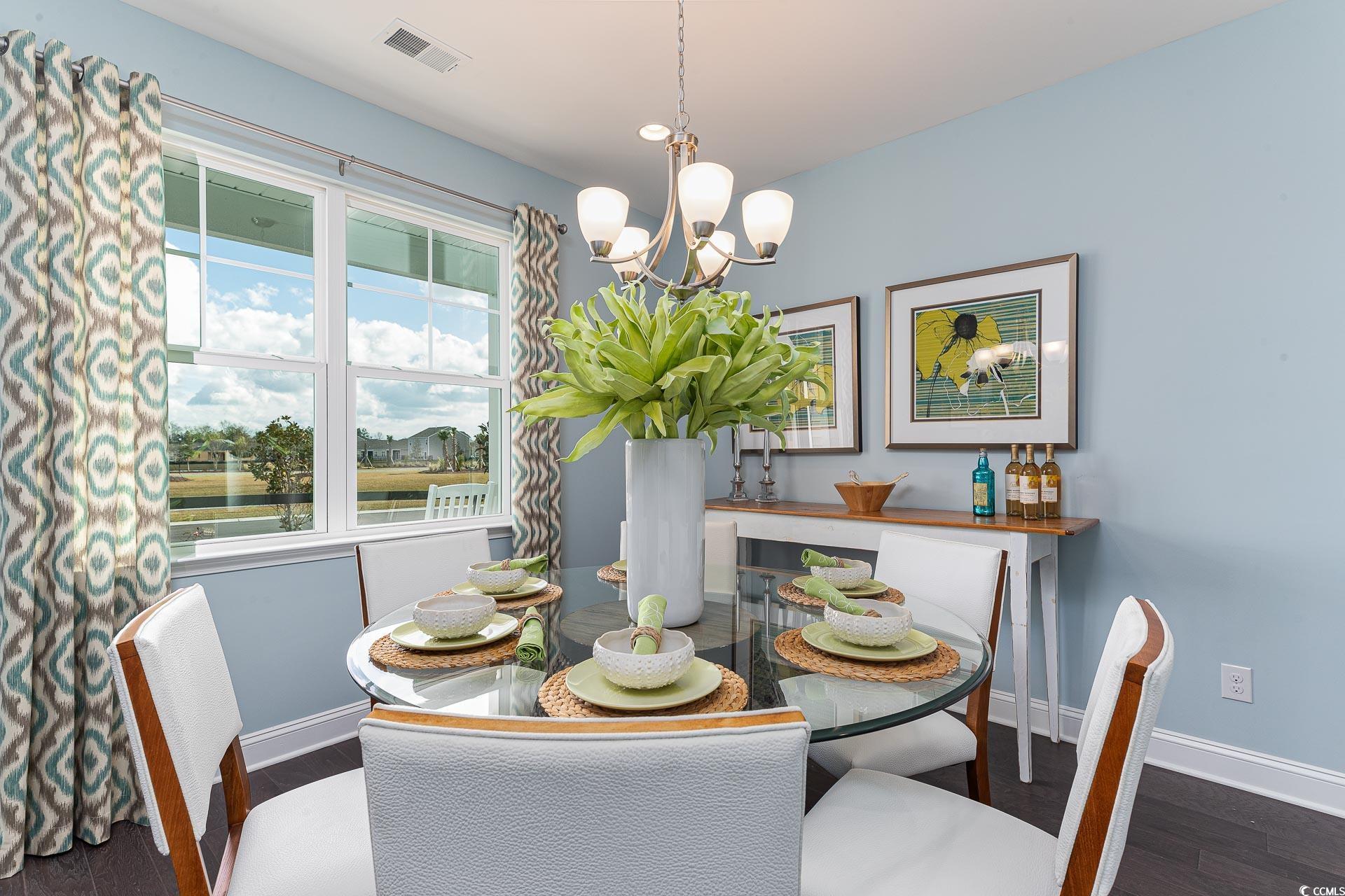 167 Bjorn Way Loris, SC 29569 - Photo 15 of 40 Dining area featuring a chandelier, wood finished floors, and a water view