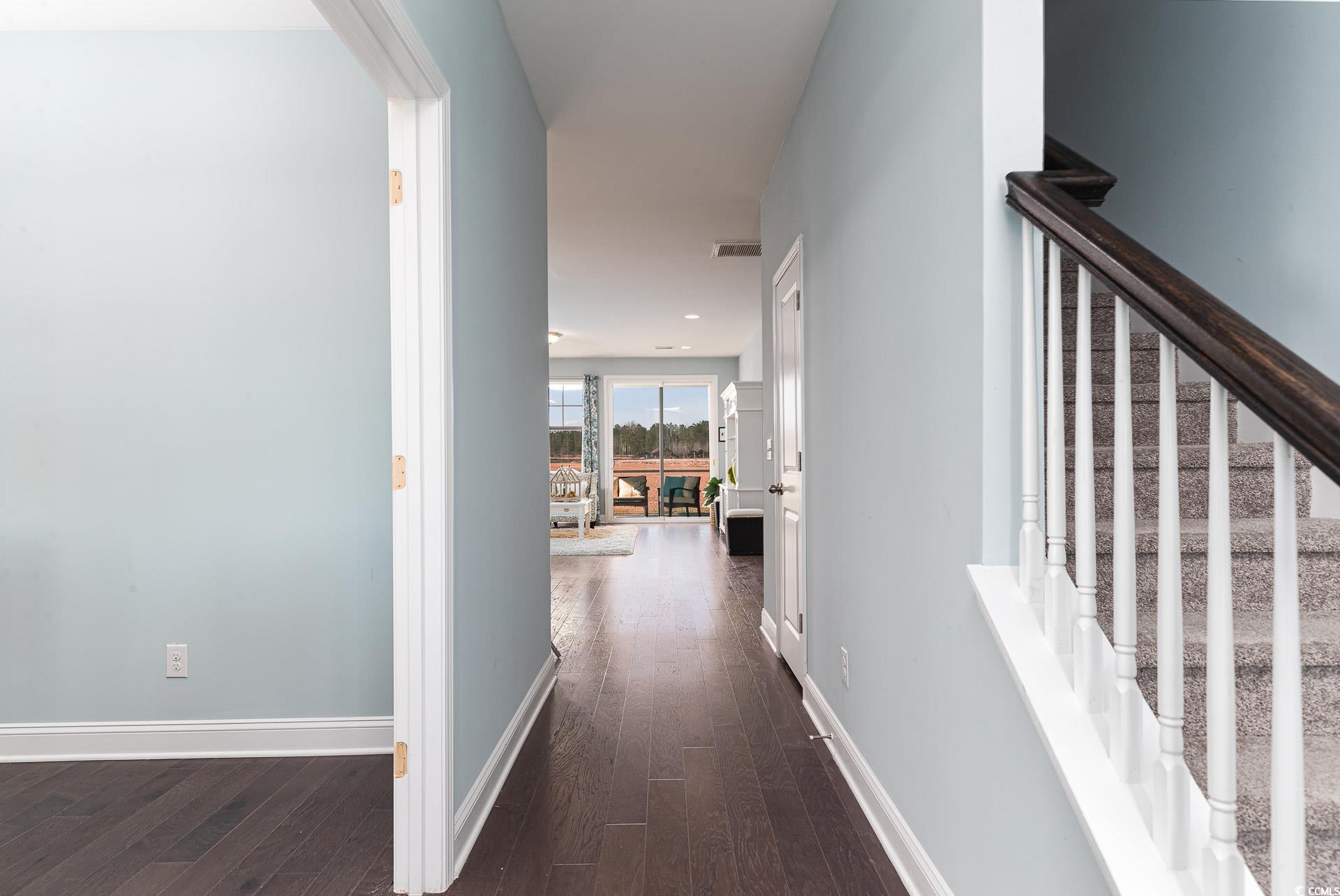 167 Bjorn Way Loris, SC 29569 - Photo 6 of 40 Hallway featuring dark wood-style floors and stairs