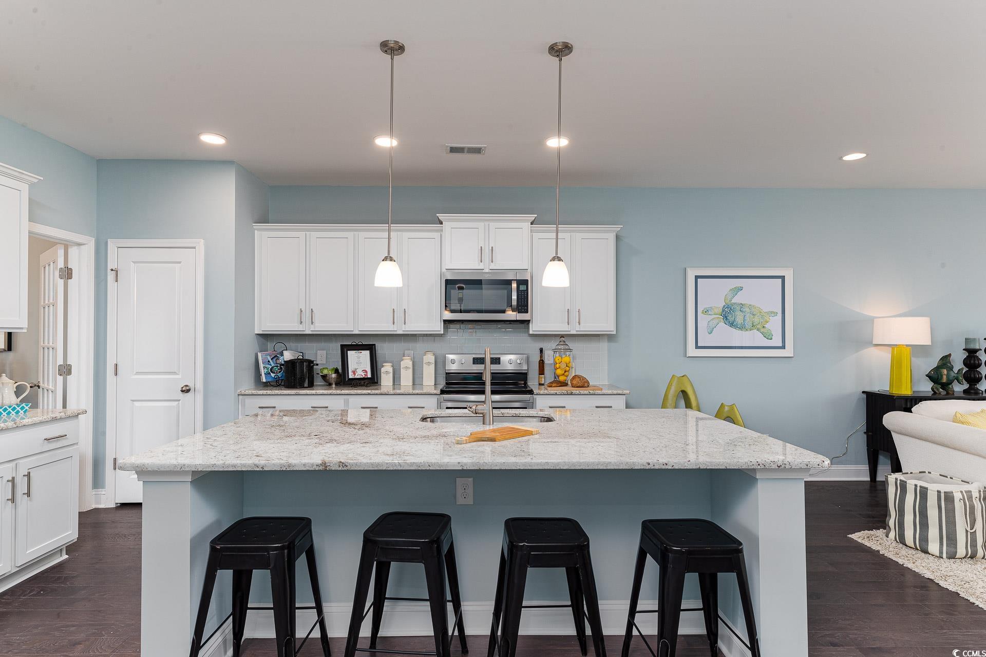 167 Bjorn Way Loris, SC 29569 - Photo 8 of 40 Kitchen with dark wood finished floors, a kitchen bar, stainless steel appliances, and recessed lighting