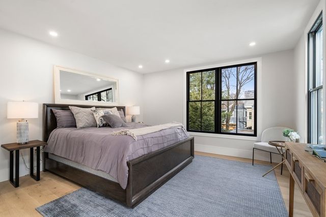 a spacious bedroom with a bed and a window