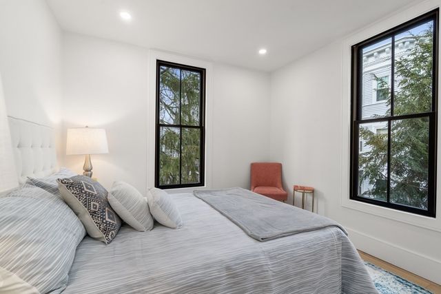 a bedroom with a large bed and a window