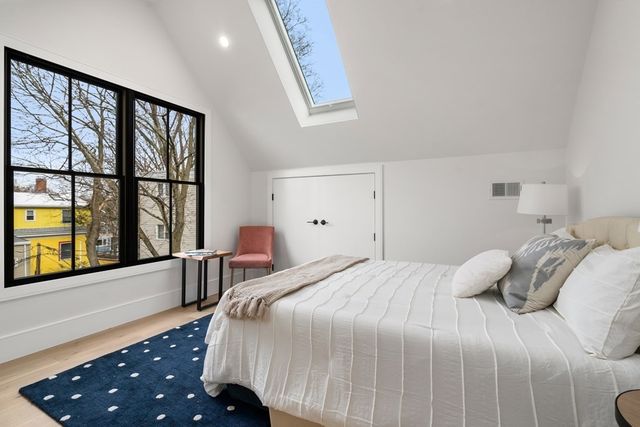 a bedroom with a large bed and a large window