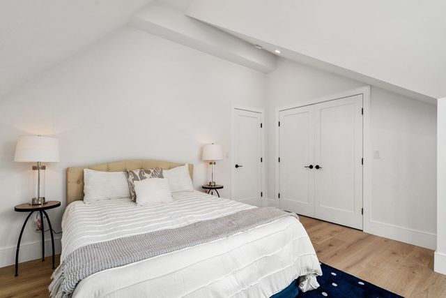 a bedroom with a bed and a night stand